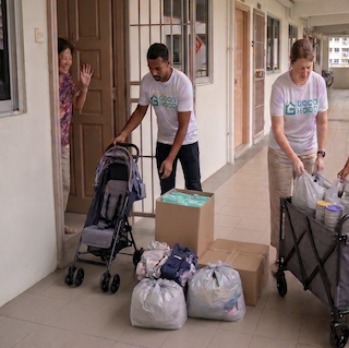 Volunteers collecting pre-loved items at a doorstep